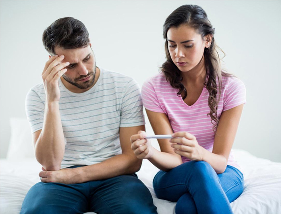 Unhappy Couple Checking Pregnancy Test
