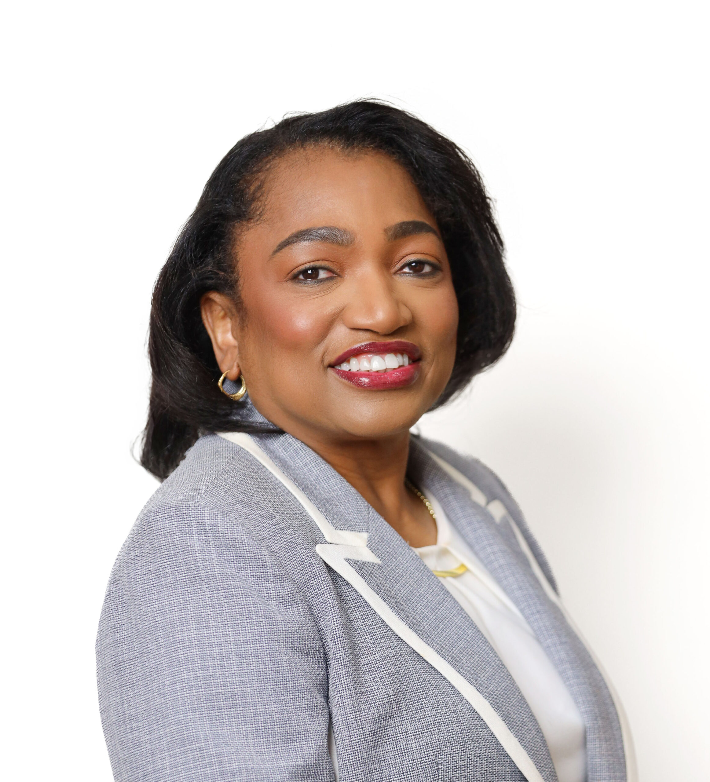 Woman in grey formal attire smiling